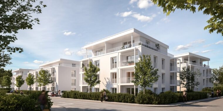 Moderne Wohnanlage mit weißen Gebäuden, Balkonen und begrünten Außenanlagen in einer städtischen Umgebung.